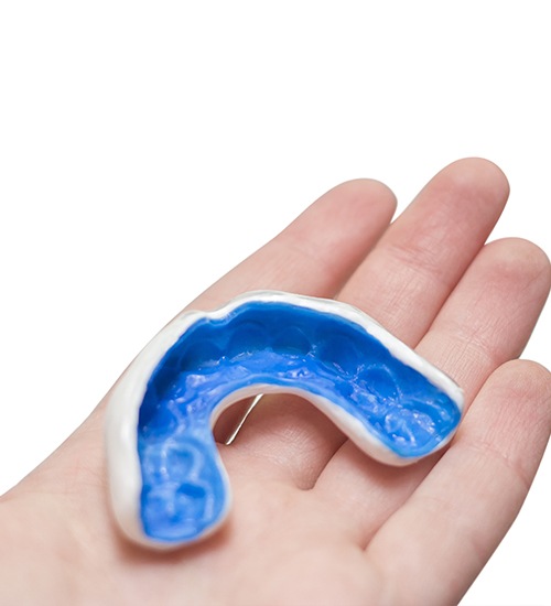 hand holding athletic mouthguard