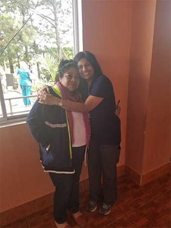 Dr. Kurian hugging female staff member