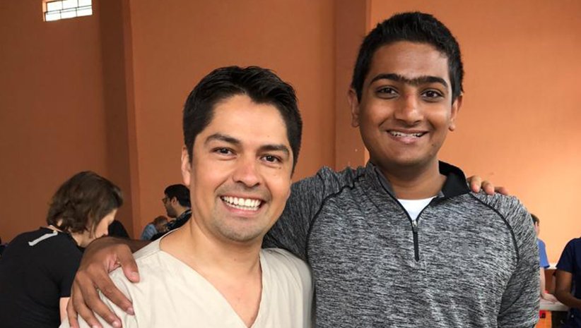 Dr. Kurian's son and male dentist smiling