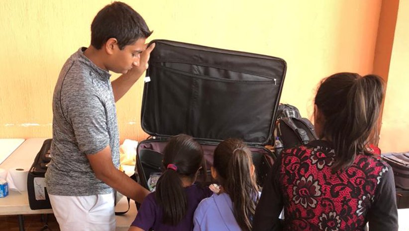 Dr. Kurian's son letting kids pick out a toy