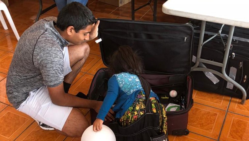 Dr. Kurian's son letting young girl pick out a toy