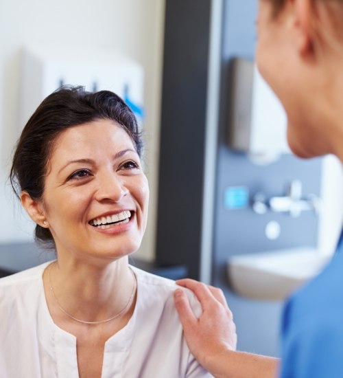 woman speaking with dentist