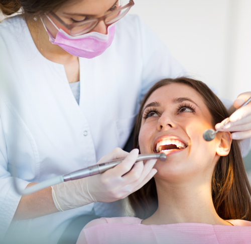 dentist checking patients smile