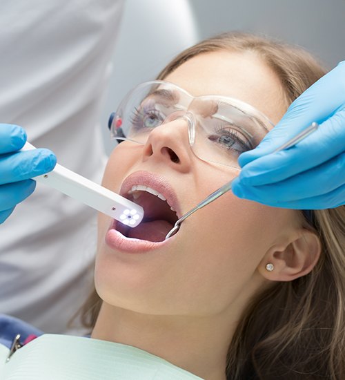 girl with intraoral camera in mouth